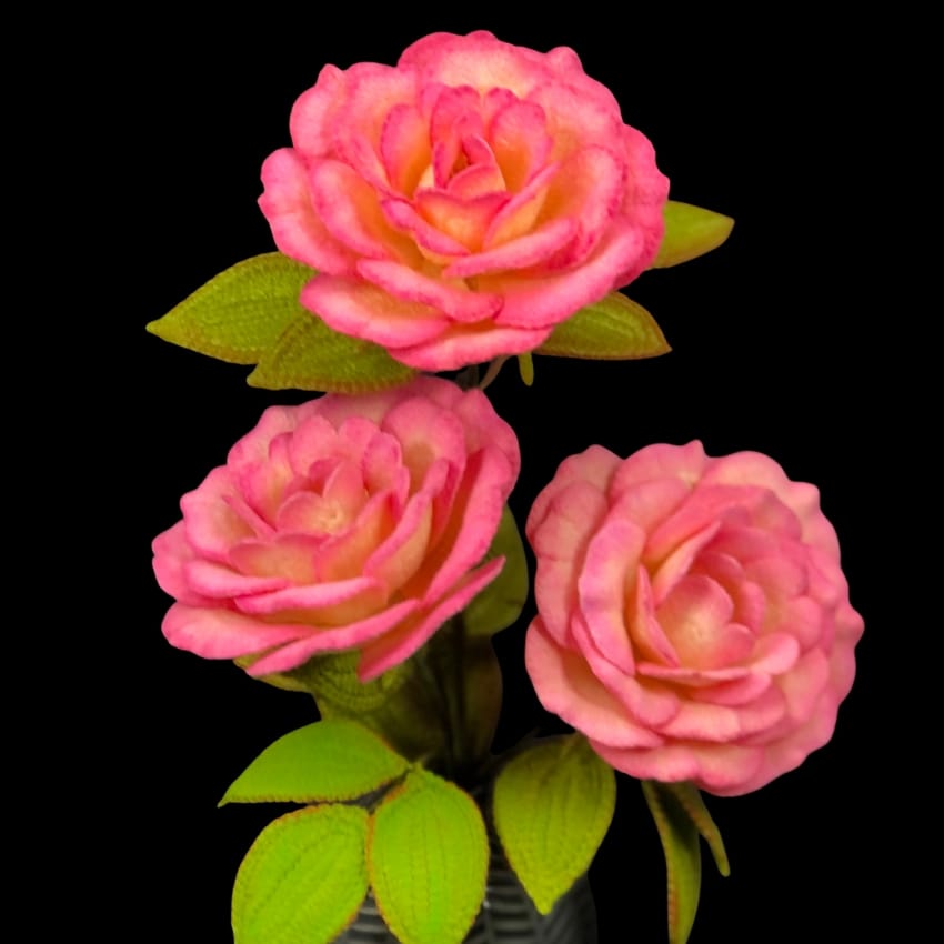 Handel Rose Crochet Pattern Three pink crochet hadel roses with green leaves